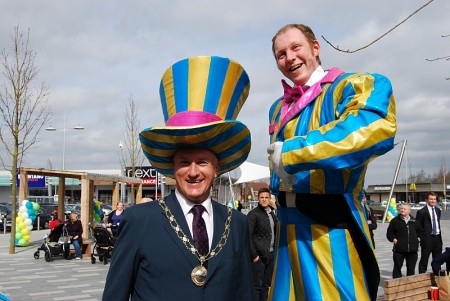 Cllr Ian Boulton with a stilt walker.