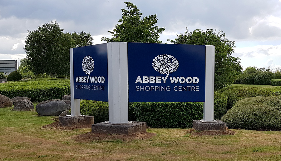 Photo of a sign at the entrance to Abbey Wood Shopping Centre.